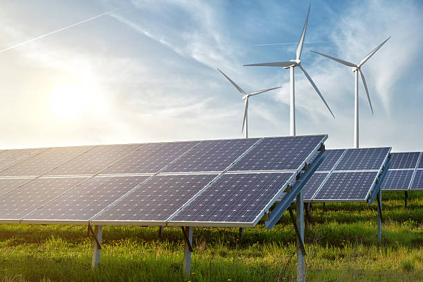 solar panels and wind generators under blue sky on sunset Setor de energia solar atinge a marca de 1 milhão de empregos gerados no Brasil